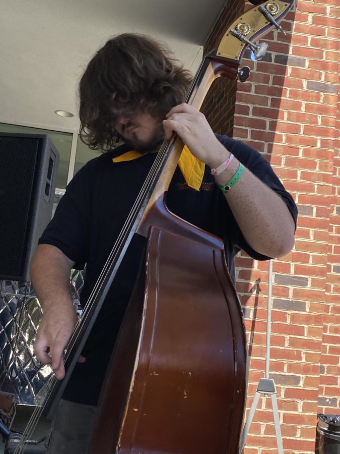 Stewart Werner thumps the stand-up bass during the ice-cream social on campus Wednesday.