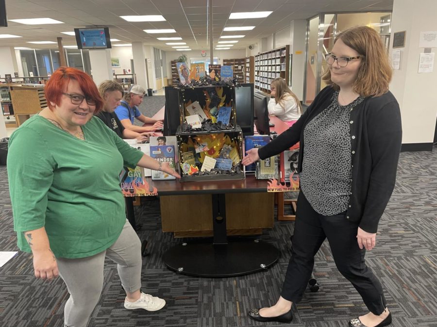 Rachel Walton and Sierra Alley show off the flames book display. 