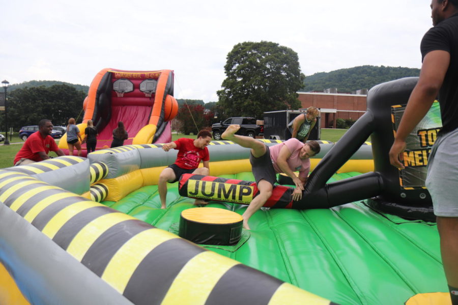 Students tumble through the American-Ninja-style bouncy obstacles during the First Week activities.