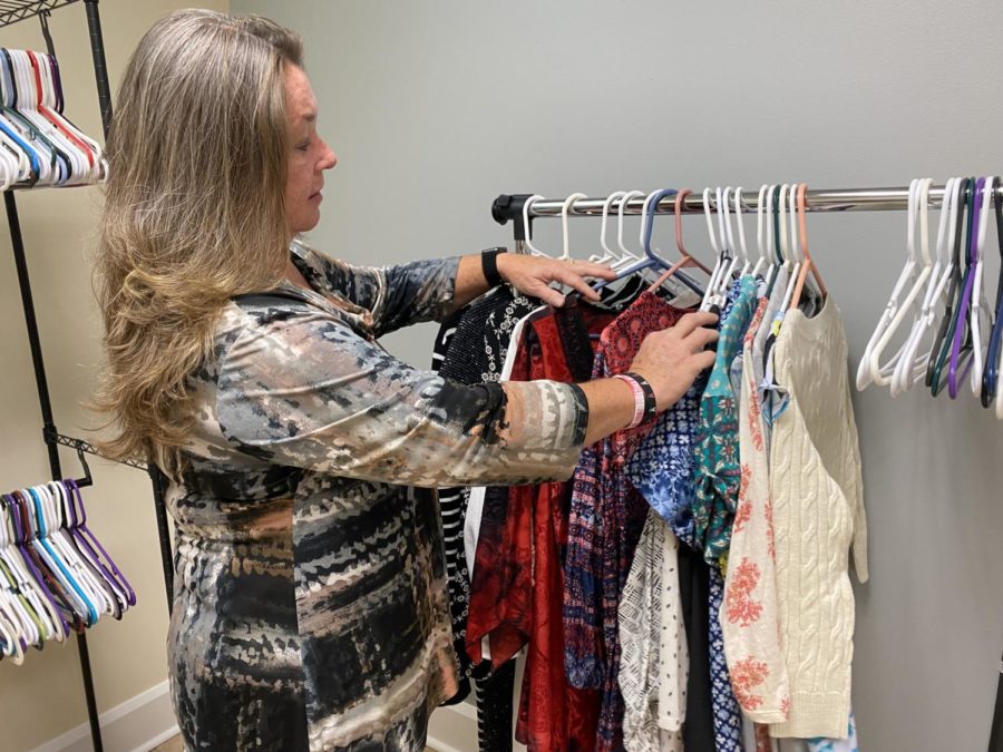 Sandy Pagans, Coordinator of Student and Family Support, goes through clothing in the Career Closet. 