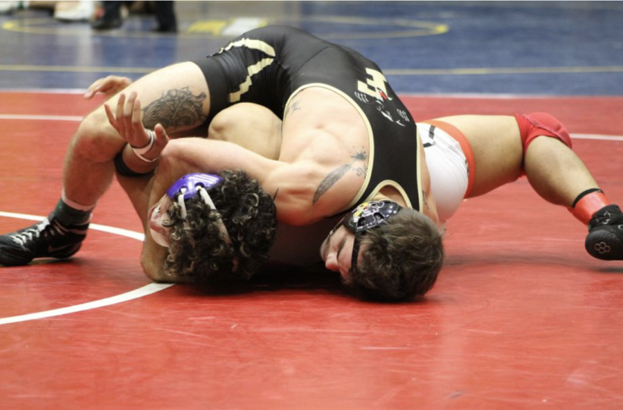 Elijah+Martin%2C+senior%2C+goes++5-0+with+two+pins+and+winning+the+157-pound+title.