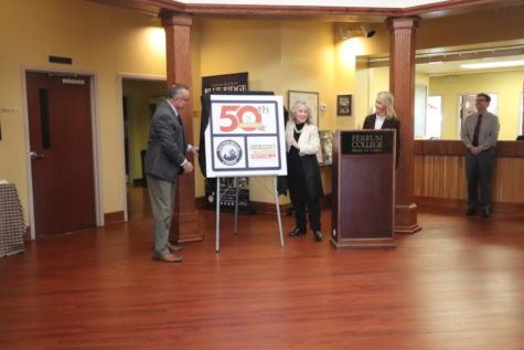 Interim President Mirta Martin, center, and Tim Tatum, Franklin County Supervisor from the Blue Ridge District, left, reveal the new logo for the 50th anniversary. BRI Director Bethany Worley stands behind the podium at right, while Vice President of Academic Affairs, Kevin Reilly, far right, looks on.  