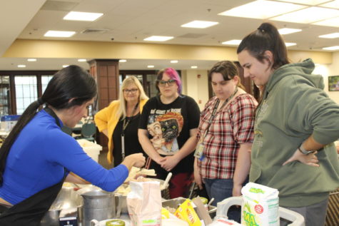 Andrea Velazquez-Juarez demonstrates tamale-making to students and faculty at the recent station takeover in the cafeteria. 
