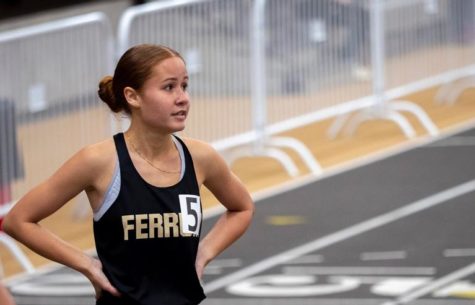 Genesis Pineiro, senior, catches her breath after a race.