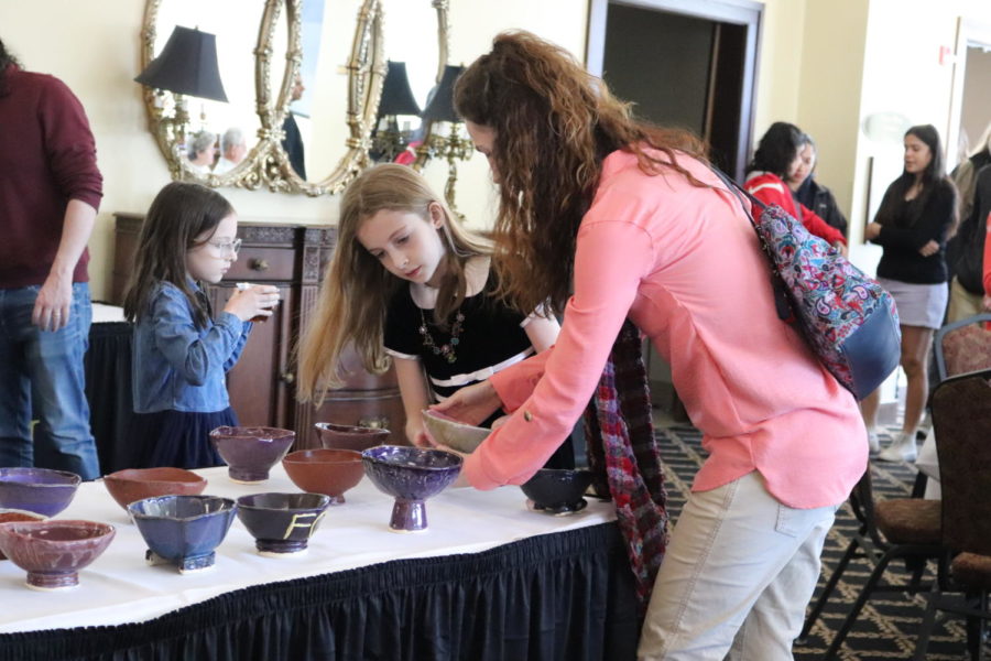 From left, Sylvia, Evelyn, and Angela Bowman select bowls during the event.