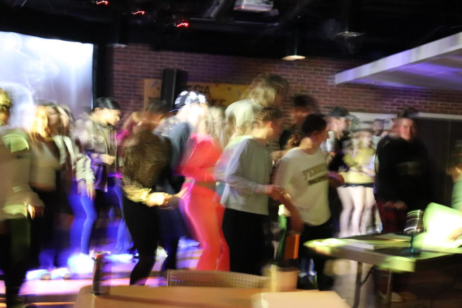 Students dance together during a group song on Karaoke Night.