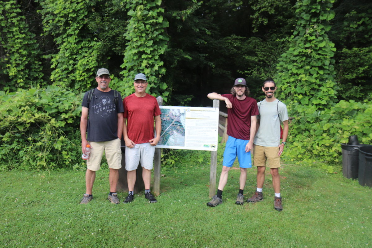 From left, Brian Bingham, Recreation Leadership Professor Dan Caston, Kyle Hayhurst, and Seijin Campbell stand at the entrance to the colleges disc golf course. 