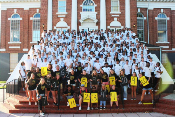 The Connection Leaders and the Class of 2027 pose for a photo on the steps of the Sale Theatre.