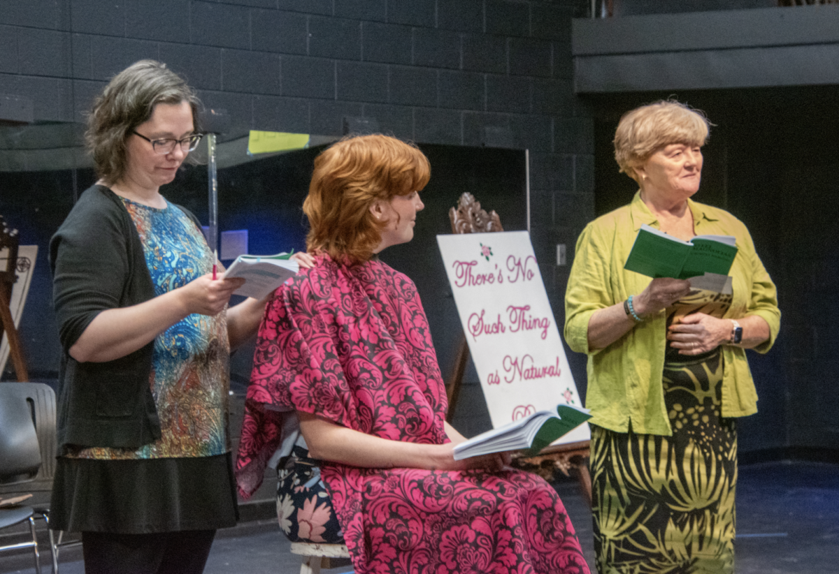 From left, Truvy (played by Theatre Arts Professdor, Rebecca Crocker), styles Shelbys (played by TJ Baker, senior) hair, while Clairee (English Professor Lana Whited) looks on.