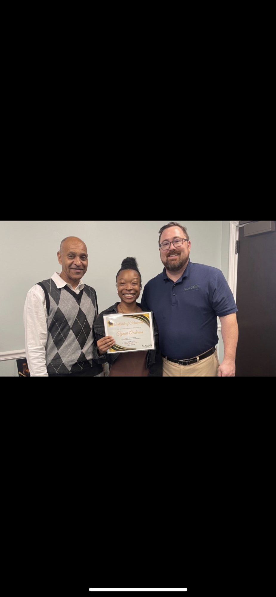 Tynair Anderson receives her Aladdin Food Services scholarship last year with Michael Ferguson (left), and Levi Briggs (right).
