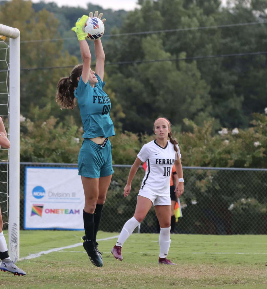 Ashli Wuss, sophomore, stretches to grab a ball out of the air and prevent a Virginia Wesleyan University goal.