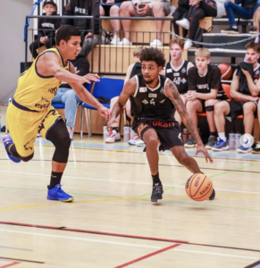 Former Panther Deshone Hicks (right) drives to the basket for a layup against his defender in a game for the Finland Raider Basket pro team.