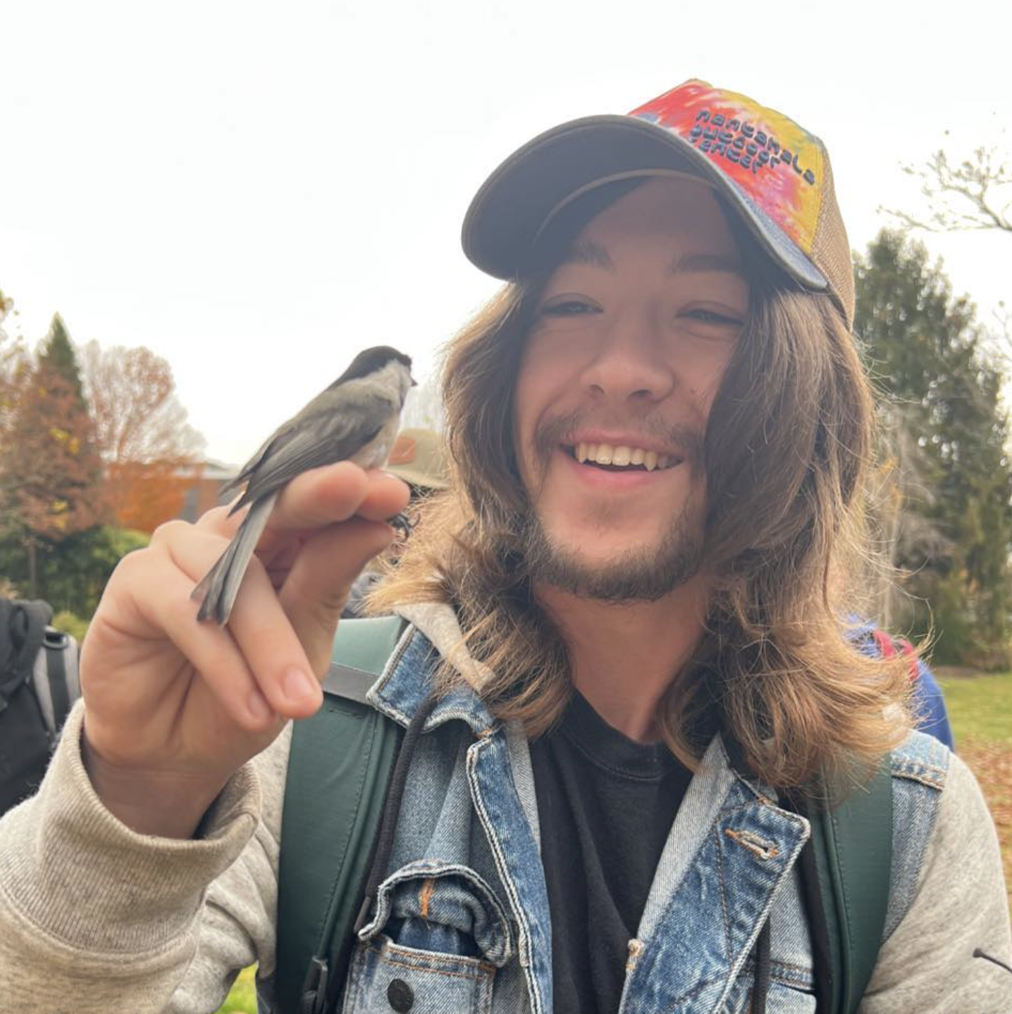 Communing with nature, Alex Reed, junior, watches as a bird perches on his finger.