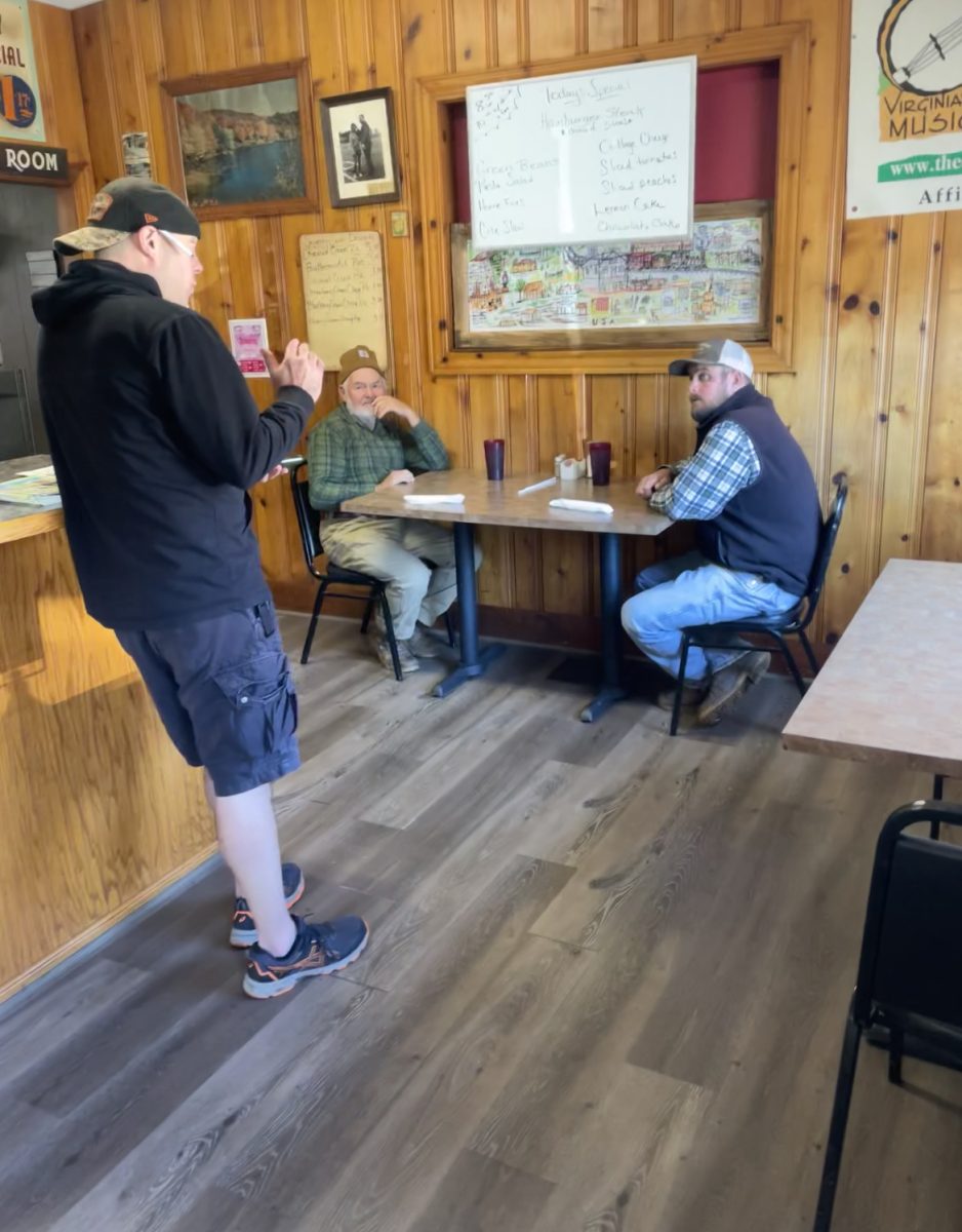 Brad Dalton, 77 Restaurant owner, speaks with customers about travel baseball.