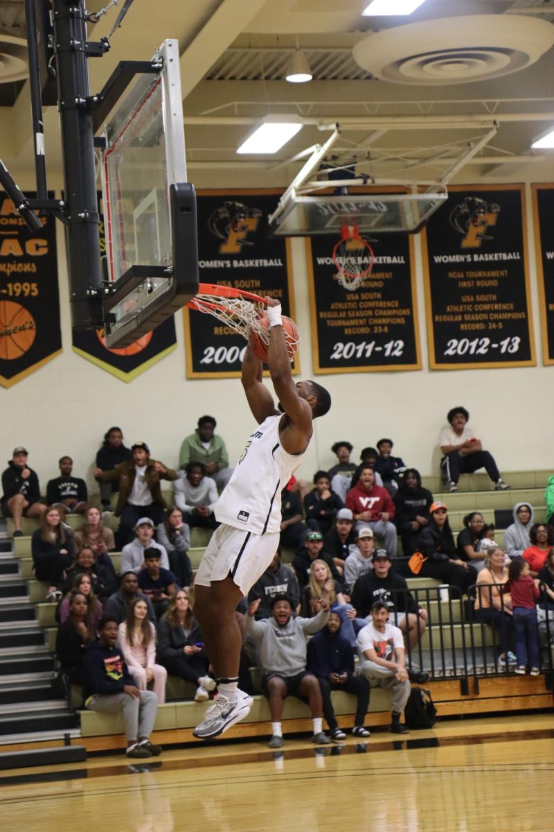 Darwin Randolph, junior, records one of his dunks on the afternoon in the Panthers 107-52 trouncing of the Mustangs on Saturday.