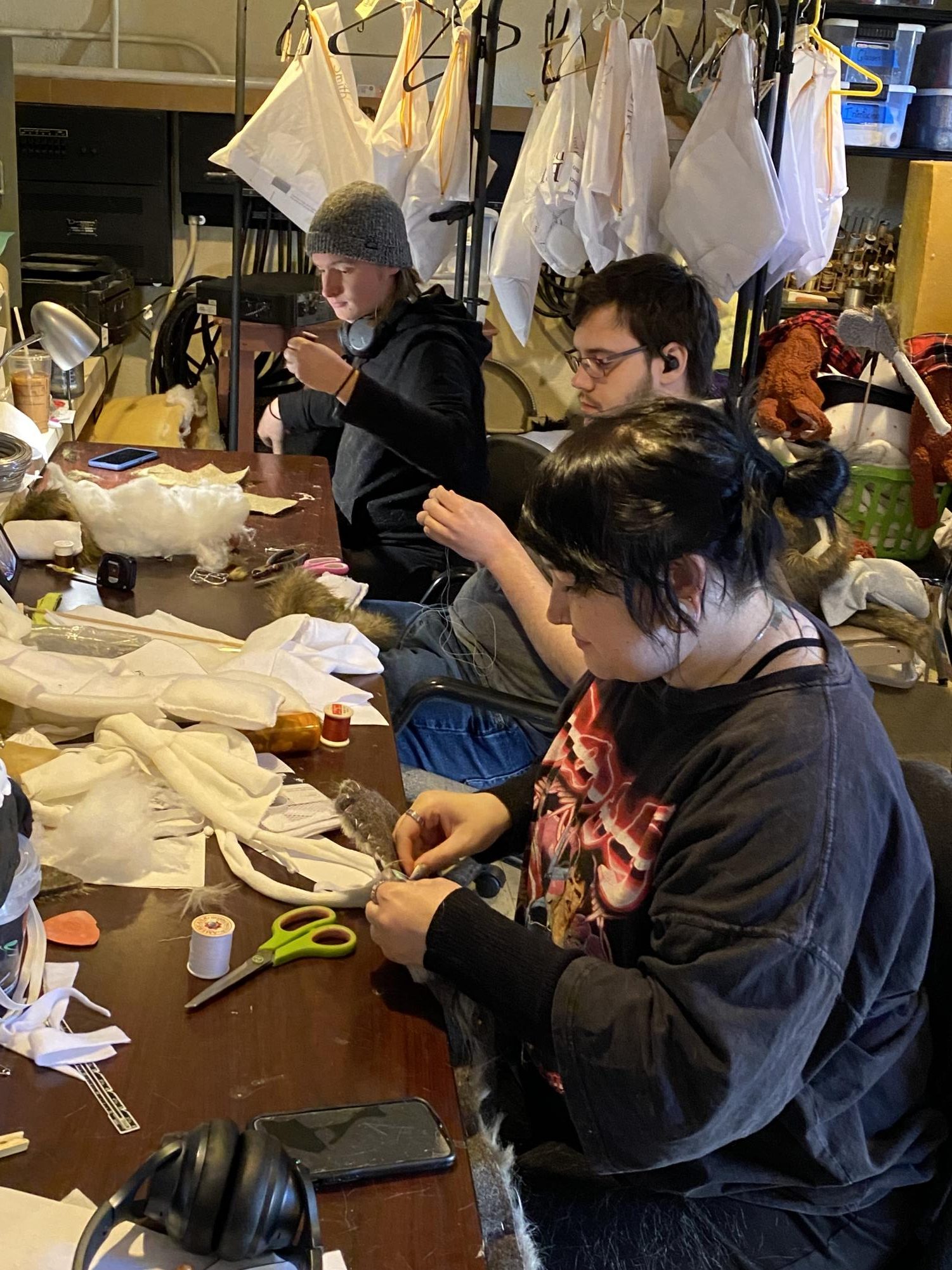 From left, Gage Shelton, junior; Troy Smith, junior; and Scout Lynch, sophomore; begin the process of bringing puppets to life via needle and thread.