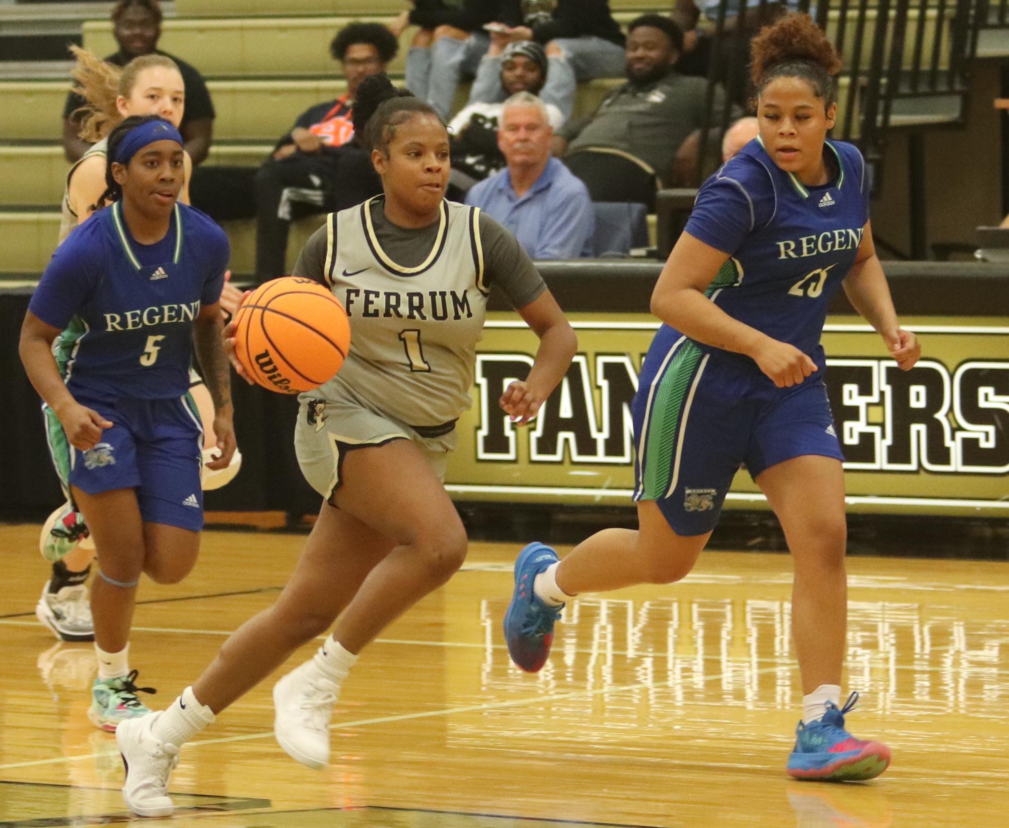Kayla Cabiness, senior, brings the ball up the court against Regent University on Sunday in Swartz Gym. Cabiness was the games leading scorer with 28 points.