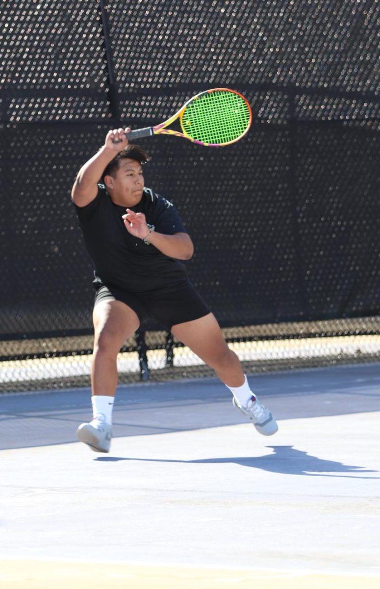 Jairo Herbas, freshman, forehands the ball to his opponents on the opposite side of the court. 