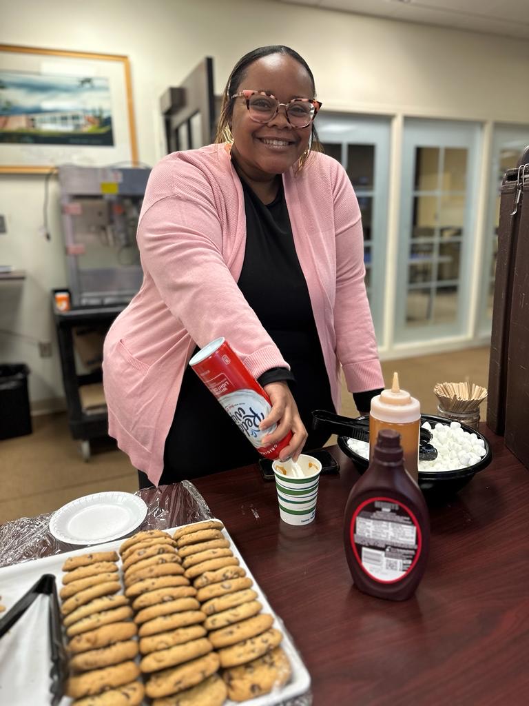 Lacey Matthews coordinator of Residence Life and Programing, puts the finishing touch of whipped cream in her hot chocolate.