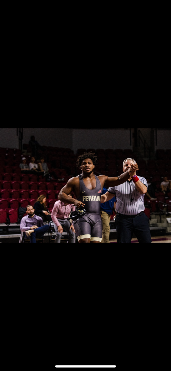 Rayshawn Dixons hand is raised after a another victorious match.