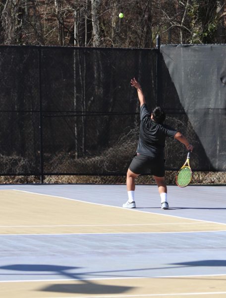 Jairo Herbas, freshman, warms up with the ball as he prepares to face his opponents on the court.