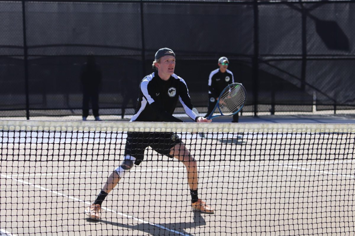 At right, Tripoom Jala, junior, and Kevin Nester, junior, prepare for the ball in an intense doubles match. 
