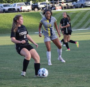 Ashlynn Mitcham, senior, passes the ball in preseason match against Carolina University.