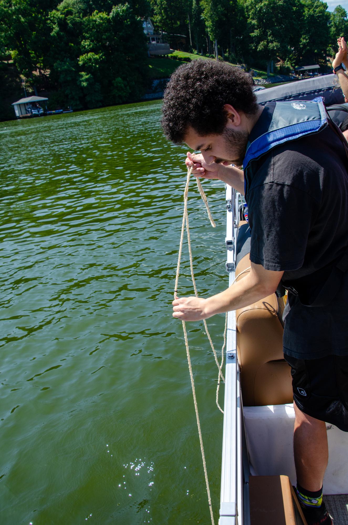 Aaron McNeal, junior, takes in a vertical algae sample with the Smith Mountain Lake Water Quality Project.