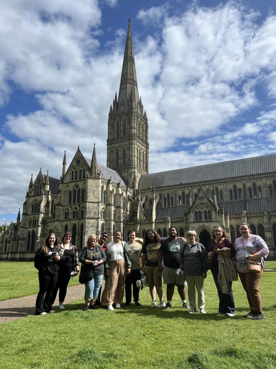 The Singing Panthers group for a photo outside the Salisbury Cathedral. From left to right, the group is: Kylie Atkins, senior; Sarah Gallagher, sophomore; Music Professor Jennifer Ayers-Barnard; D.J. Dungee, alumni; Emily Walker, senior; Gage Shelton, senior; Stewart Werner, senior; Jaylon Hillman, junior; English Professor Lana Whited; Annette Patrick; Ashley Patrick, alumni. 