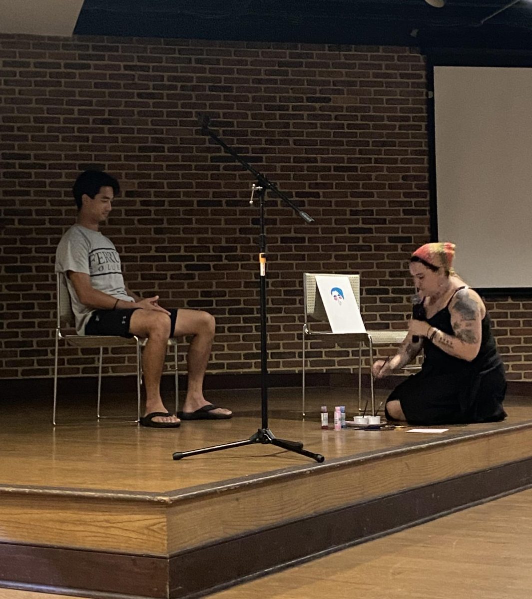 Scout Lynch, senior, performs an artistic demonstration at the first coffee house of the semester.