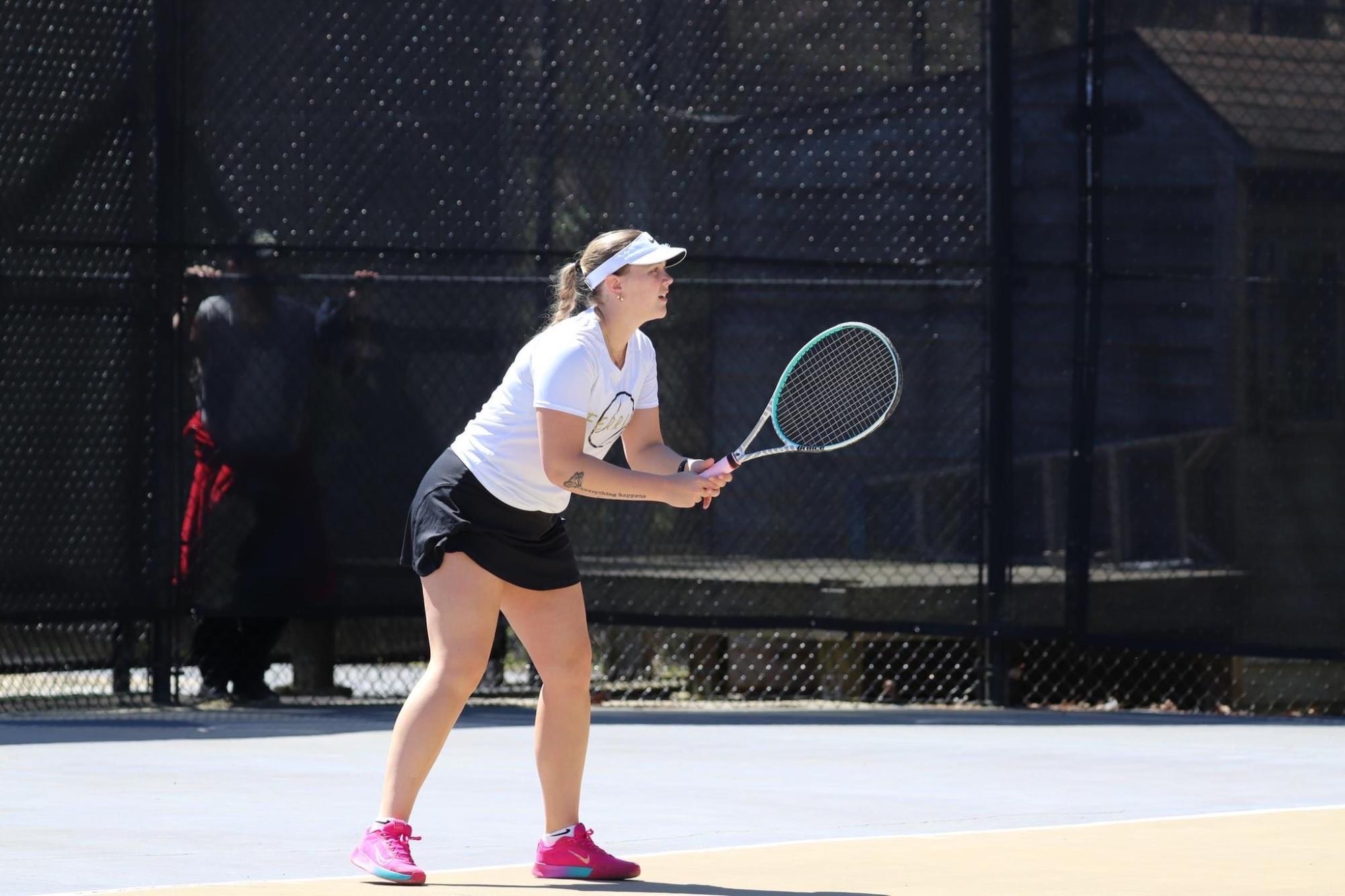 Hannah Huffman. senior, readies herself for the next shot with the tennis team. 