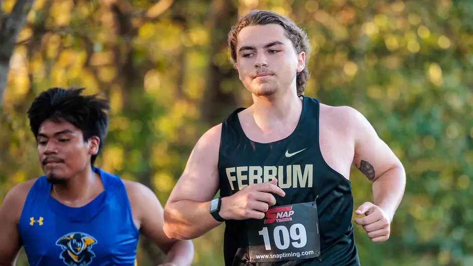 Senior Greyson Crouch treks across the 8k trail at the Lancer Open. 