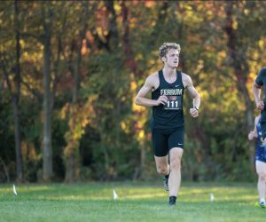 Junior Josh Mills sprints towards the finish line, leaving the eight kilometers of race behind him. 