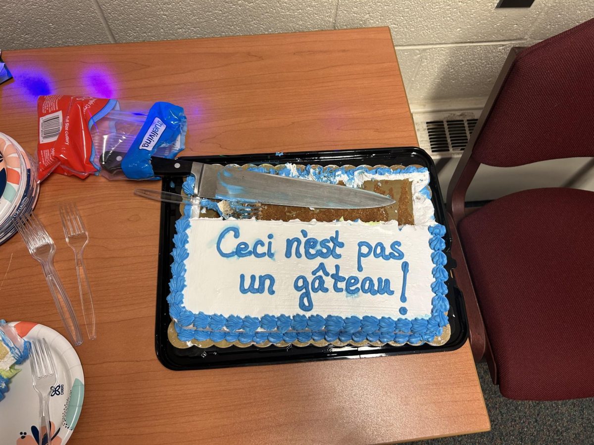 A half-eaten cake with a slogan of the surrealistic movement was a feature of the event. The icing reads, "this is not a cake".