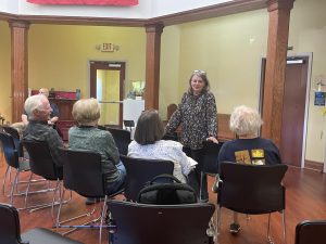 FF member Tina Hanlon chats with other members as they wait for the October meeting to commence. 