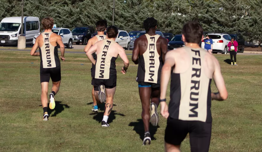 Men's XC warms up on the crisp Saturday morning before their meet begins. 