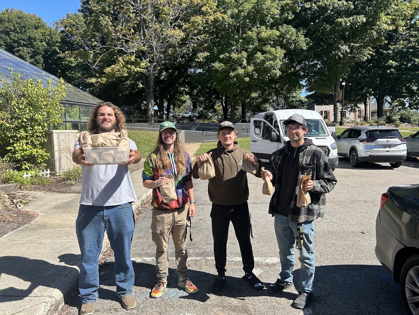 From left to right: Trent Ray, senior; Alex Reed, senior; Perry Roller, junior; Richard Marshall, sophomore; return to campus with the nuts they collected.