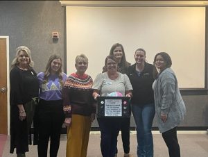 Professors and students alike gather around Educational Support Navigator Amy Fender and Associate Director of Education Alma Morgan following the tear-jerking presentation. 