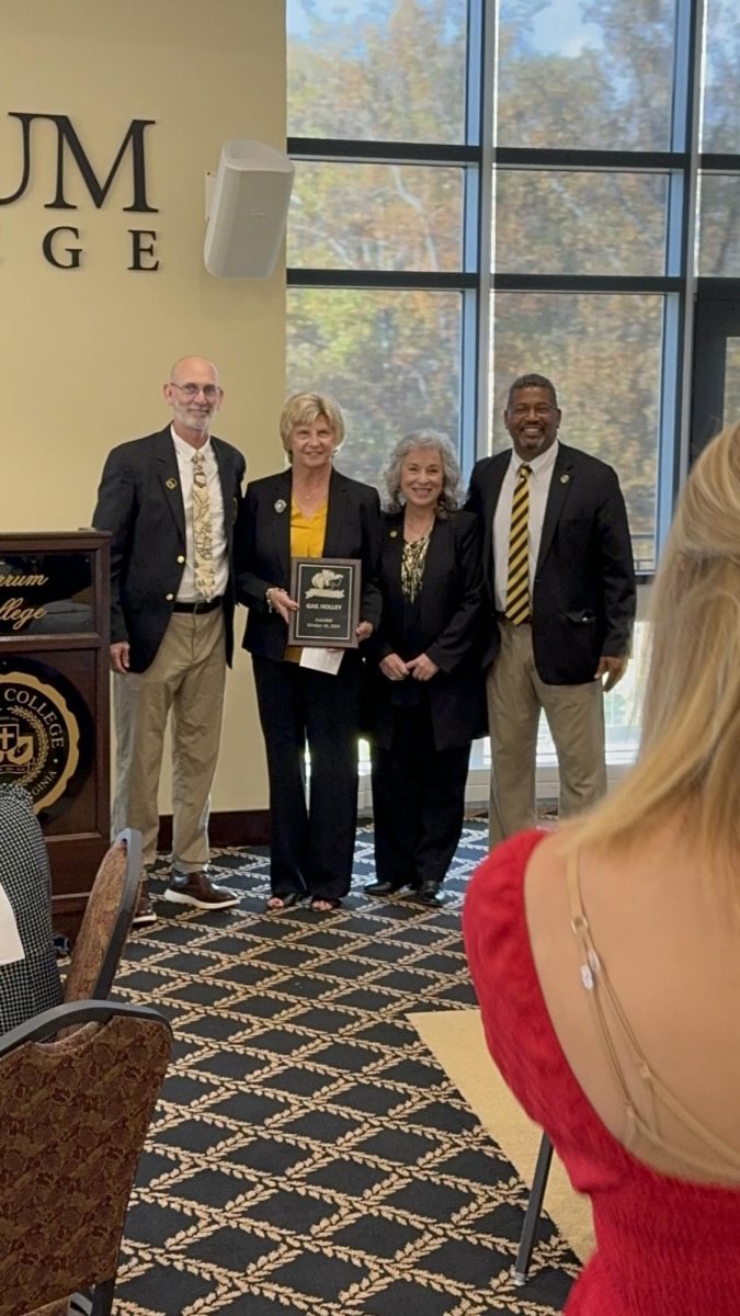 From left: Sports Information Director Gary Holden, Hall of Famer Gail Holley, President Mirta Martin, and Athletic Director Cleive Adams pause for a quick photo during the HOF honors.