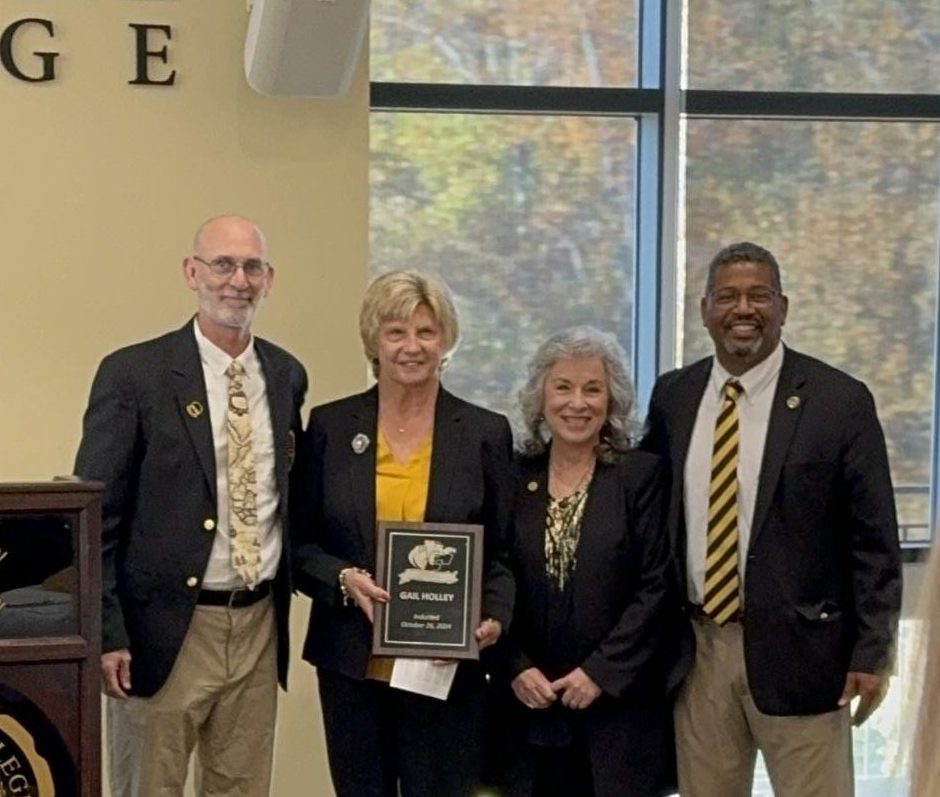 From left: Sports Information Director Gary Holden, Hall of Famer Gail Holley, President Mirta Martin, and Athletic Director Cleive Adams pause for a quick photo during the HOF honors.