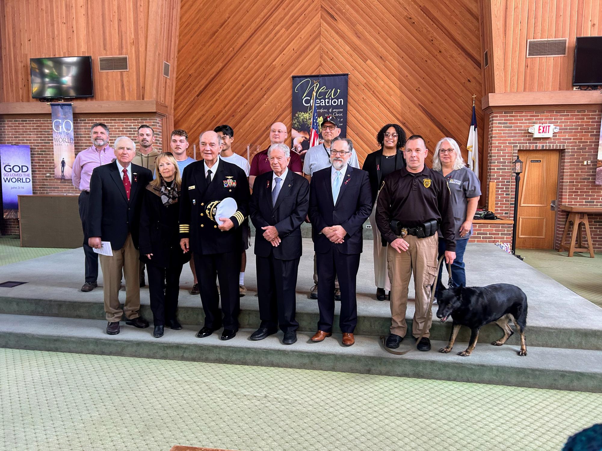 Veterans and active military personnel gather on the steps at Vaughn Chapel for a photo.