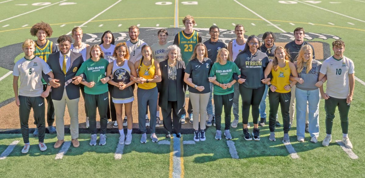 Panther and Bobcat athletes link arms in a show of solidarity and support. At center is Ferrum President Mirta Martin. 