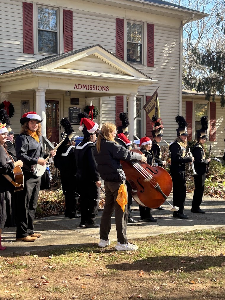 The Bluegrass Brass Explosion marches past the Stratton House during the Festival of Lights.