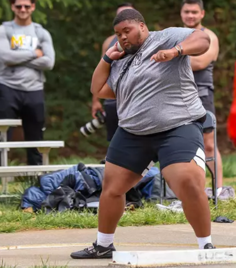 Junior Jaylon Hillman prepares to release his throw in the shot-put event. 