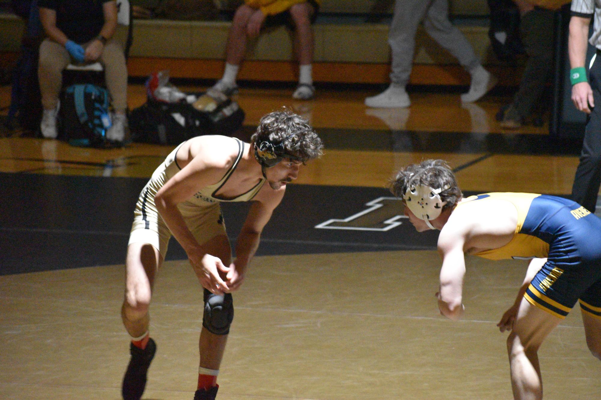 Senior Zach Beckner battles on the mat against Mason Barrett.