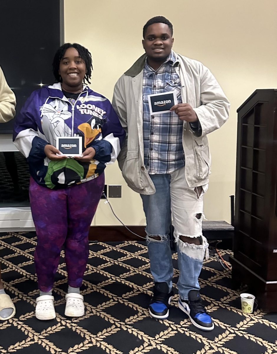 From left, sophomore Jasmyn Layton and senior Ryon Johnson hold prizes they won at Trivia Night.