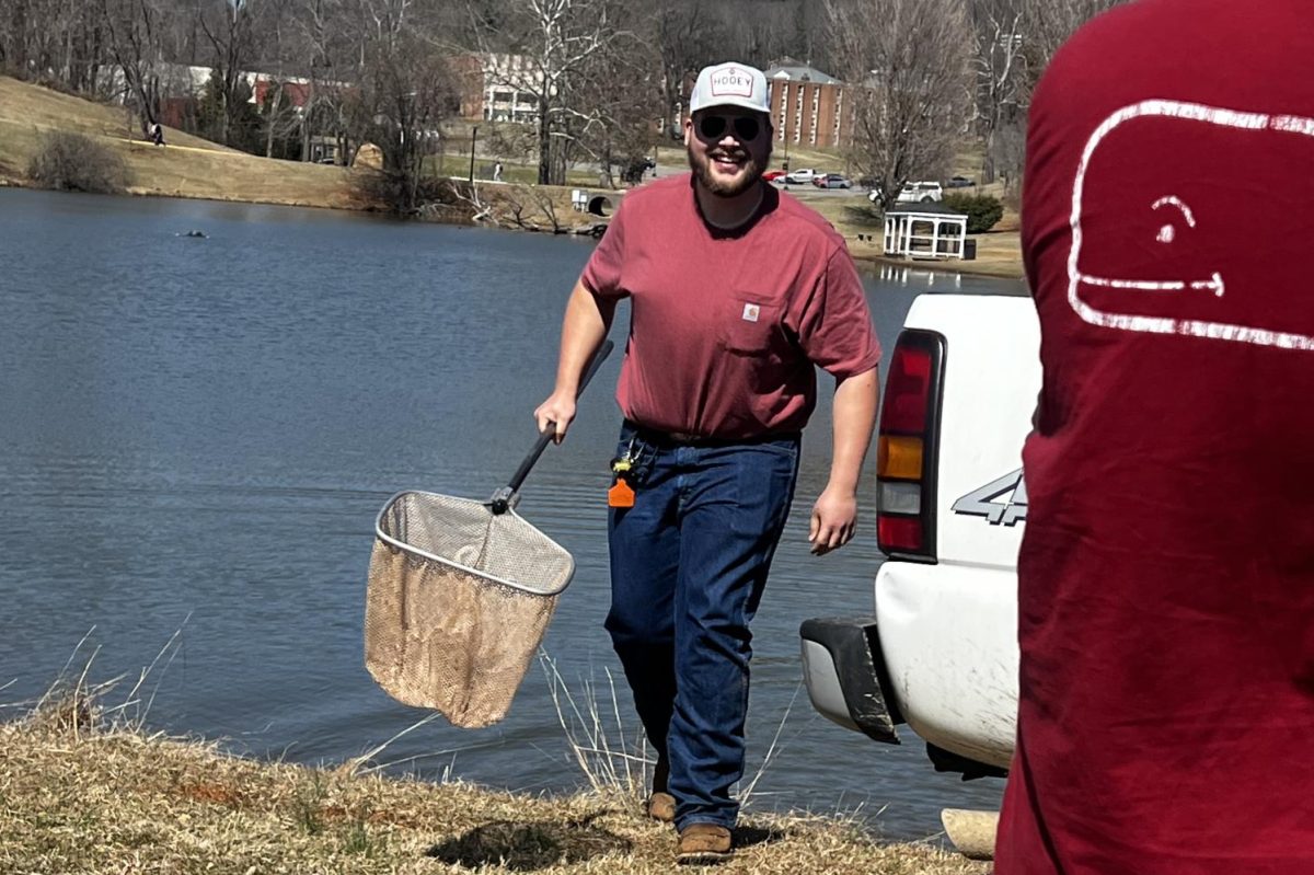 Tobias Banus, first-year, aids in the restocking of Adams Lake.