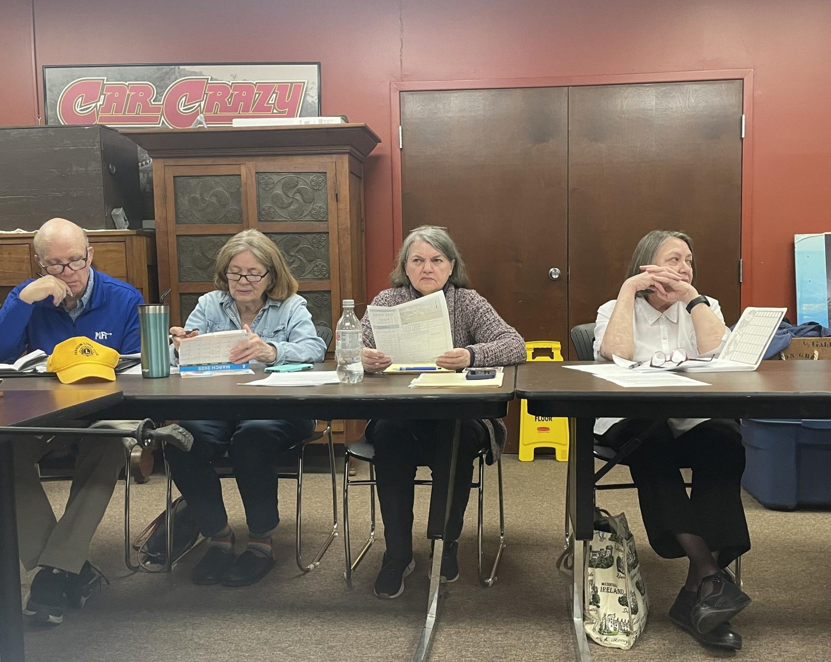 Members and attendees of the Ferrum Forward Committee March meeting discuss current events as the meeting progresses. 