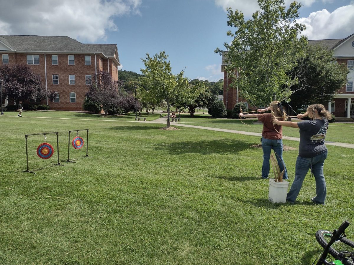 From right, Sasha Payne, first-year, and Marguerite Perdue, first-year, shoot arrows during the Norton Outdoors Expo last Thursday.