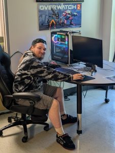 Phillip Turner, sophomore, Vice President of the Gamers Guild, shows one of the gaming PCs available for use in the studio.